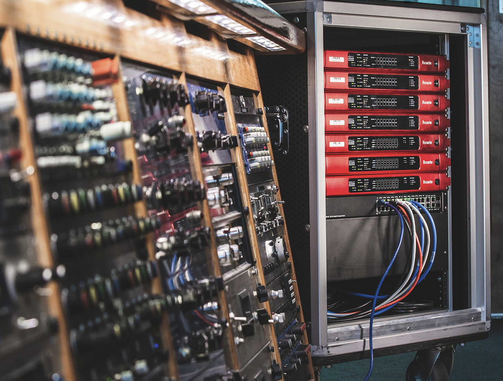 Focusrite interfaces in a rack, with other hardware to the left.